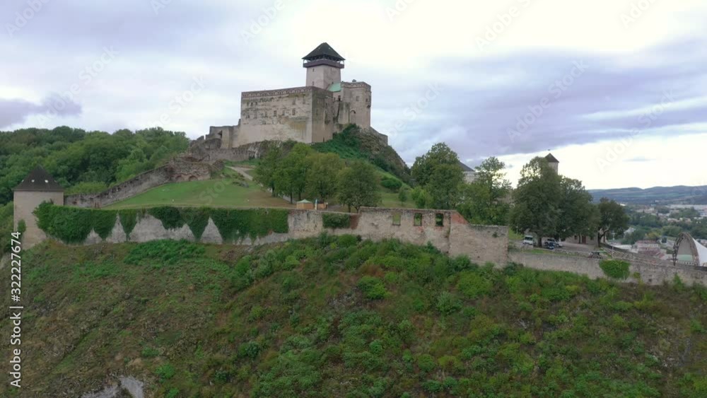 Flying up reveal video of medieval Trencin castle and town on a cloudy day in Slovakia Flying up reveal video of medieval Trencin castle and town on a cloudy day in Slovakia