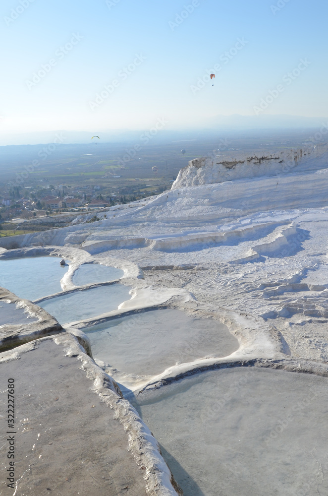 Obraz premium The calcium travertines at Pamukkale (Hierapolis), Turkey, near Denizli. Tourists can walk on the hot spring water travertine. Most of the Travertines are dry because of tourism.