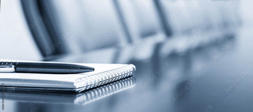 Notepad on a table with pen before meeting, blue tone, business concept with copy space - obrazy, fototapety, plakaty 
