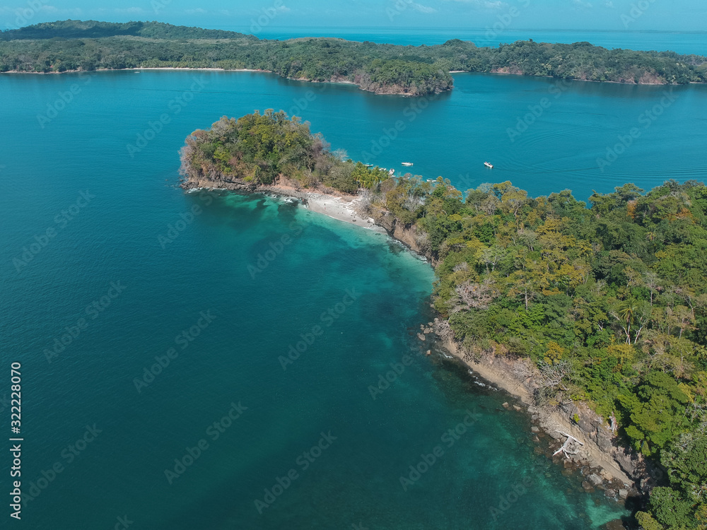 aerial drone photo of two big islands with trees at the pacific of Panama with some boats