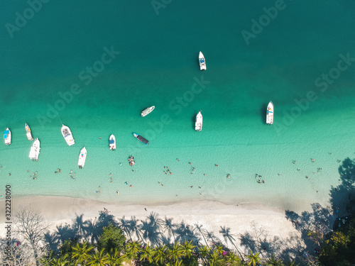 aerial top bottom drone picture with boats yachts and people playing at a beach in the pacific of Panama photo