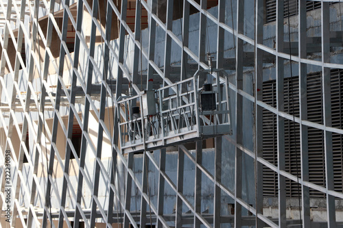 Hanging scaffold or construction platform outside of a building, being used for construction purpose.