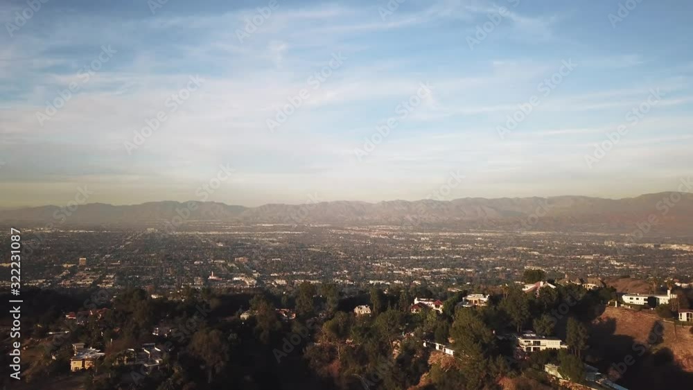Drone flying over valley in Los Angeles, California at golden hour. Drone flying over valley in Los Angeles, California at golden hour.