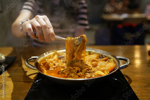 Tokpokki (Stir-fried rice cakes ) hot pot with noodles, seafood and red chili sauce, add pork and vermicelli, Traditional Korean food, The national street food of Korea. photo