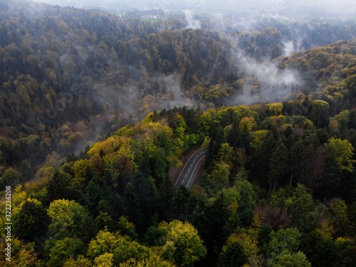 Moody aerial view of a mountain road winding through the woods in Bavaria, Germany photo