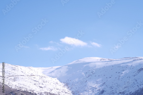 A beautyfool panoramic view of snowy mountain. Dramatic clouds. Trees in the Shed. blue sky. Mt hermon the higher mountain in Israel. © Avishay