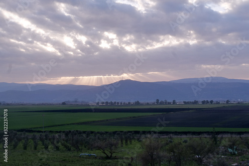 A beautifel panoramic photo of sunrise on the vally. Dramatic clouds. The sun rays.