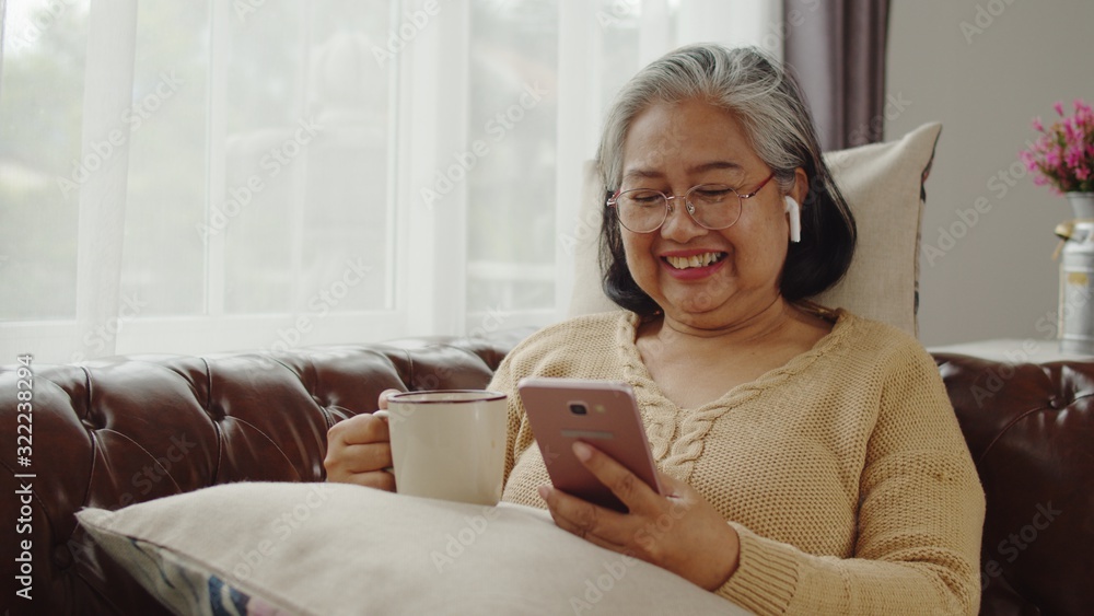 Senior woman use smartphone with happiness - obrazy, fototapety, plakaty 