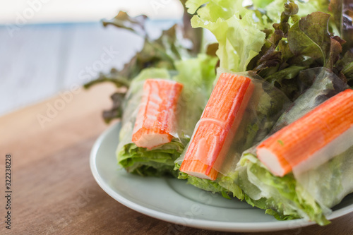Crab stick in salad roll on white dish. Healthy food concept. photo
