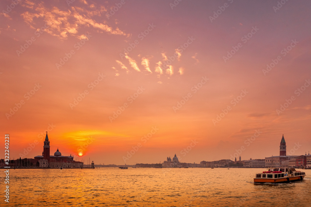 Wide view of Venice at Sunset with San Giorgio island, Santa Maria Della Salute church and the Campanile in St. Mark's Square seen Wide view of Venice at Sunset with San Giorgio island, Santa Maria Della Salute church and the Campanile in St. Mark's Square seen