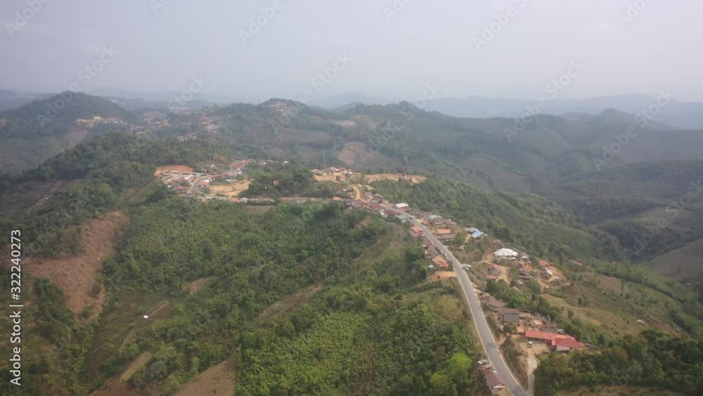 aerial scenic view of mountain road and rural village living along, in Laos. aerial scenic view of mountain road and rural village living along, in Laos.