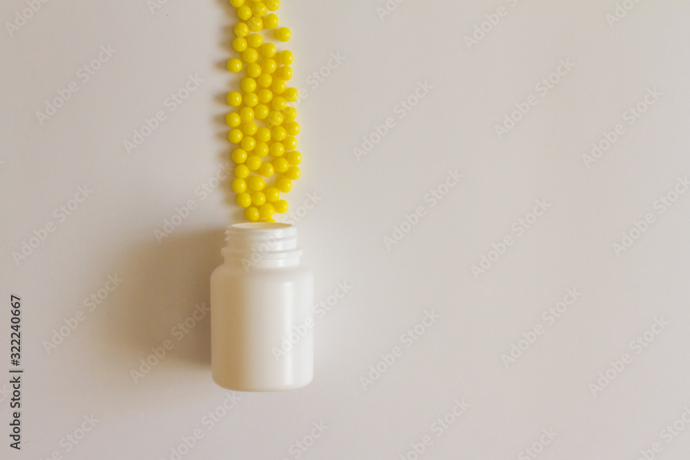 Yellow round tablets or vitamins in a white bubble, on a white background. Concept of medicine. Alternative homeopathy. Flatley. The view from the top. copyright for text.