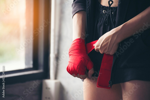 Muay Thai woman and Healthy concept. Boxing Women prepare to trianing session and kickboxing, workout at thai boxing gym. Fit Female exercise hard to strengther muscle. photo