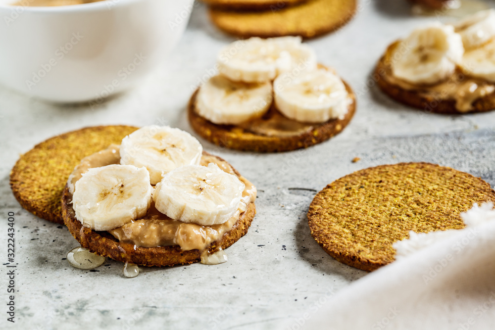 Crispbread with peanut butter, banana and honey. Vegan food concept.