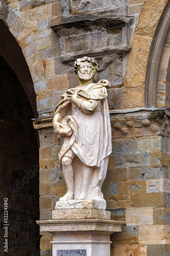 Bergamo, Italy. The statue of Torquato Tasso is an outstanding Italian poet. Sculptor Vicenzo Vela (1822-1891) .Vecchia Square. The historical part of the city. Rainy weather photo