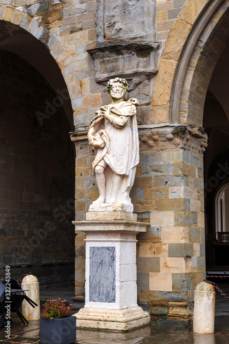 Bergamo, Italy. The statue of Torquato Tasso is an outstanding Italian poet. Sculptor Vicenzo Vela (1822-1891) .Vecchia Square. The historical part of the city. Rainy weather photo