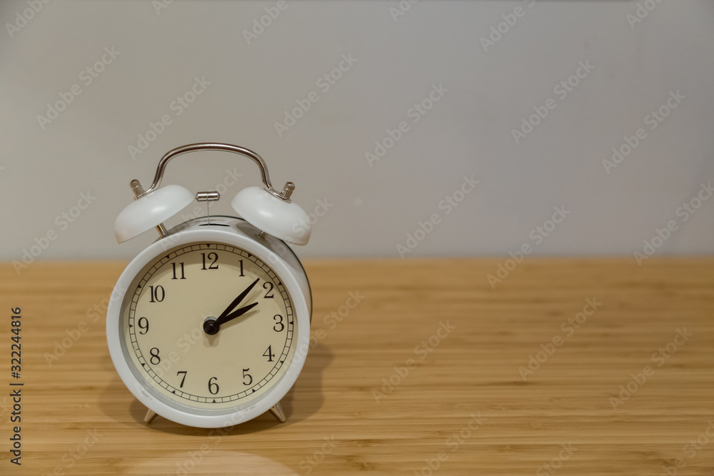 Alarm clock on the wood table beside the bed Alarm clock on the wood table beside the bed