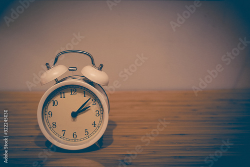 Alarm clock on the wood table beside the bed