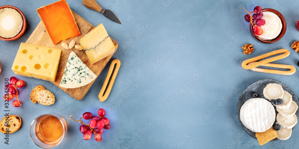 Cheese panorama. Goat cheese, Brie, blue cheese etc, shot from above with a place for text