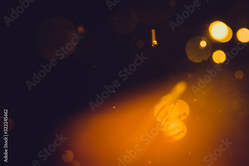 Dark Abstract Gold bokeh sparkle on black background