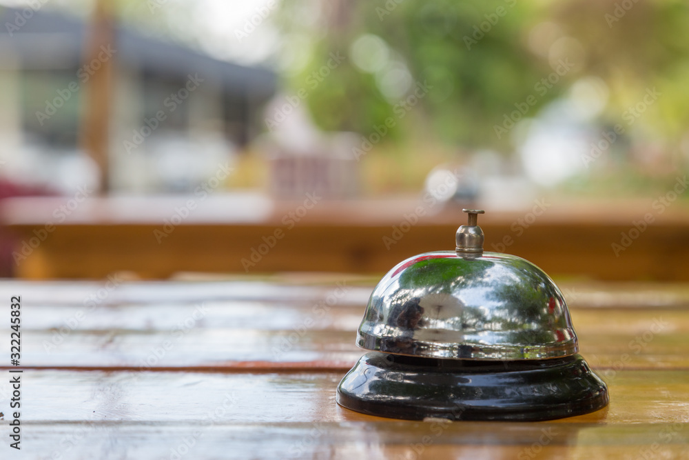 Bell on the wood table in restaurant with nature