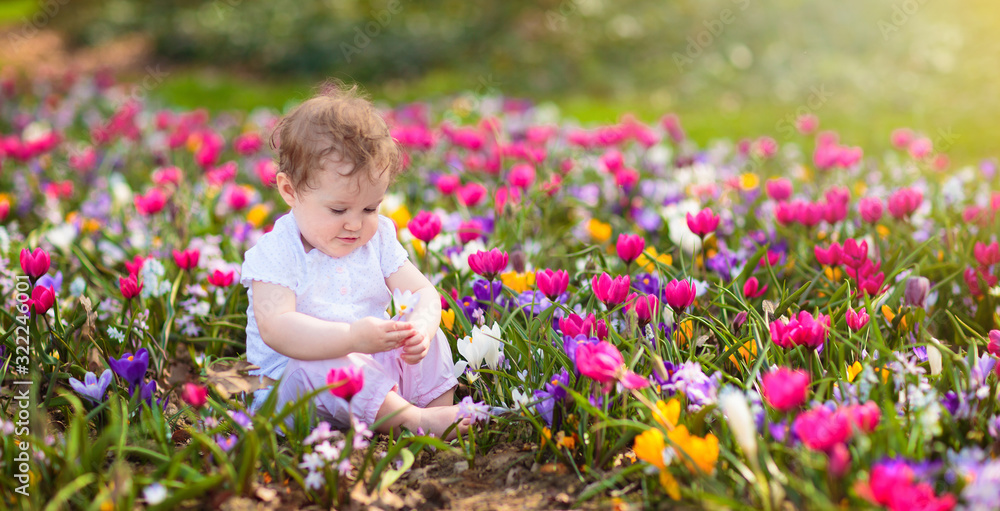 Child in spring park with flowers Child in spring park with flowers