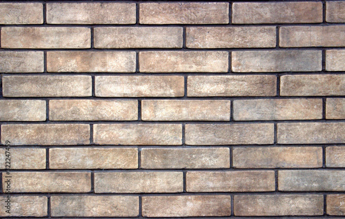 Gray brick texture. Close-up. There is a small relief on the bricks