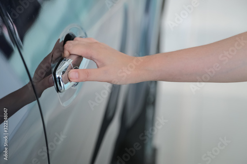 Woman hand on open the new car door