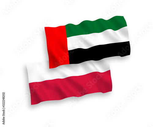 National vector fabric wave flags of United Arab Emirates and Poland isolated on white background. 1 to 2 proportion.