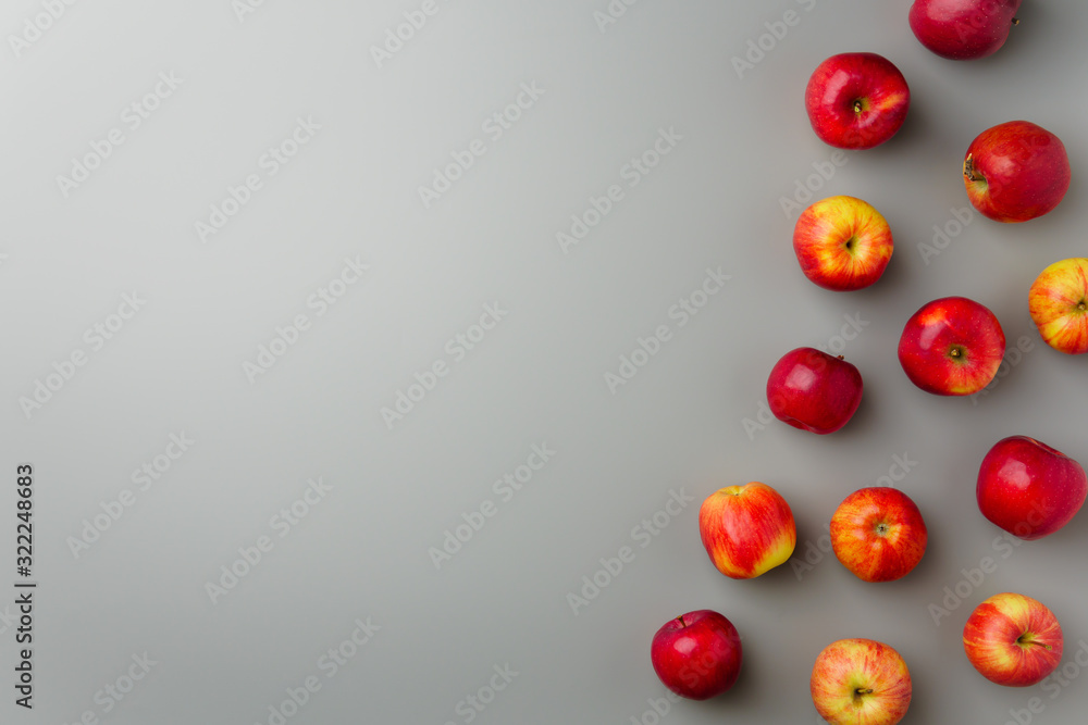 Groups red apples on a gray background. Flat lay, copy space. Groups red apples on a gray background. Flat lay, copy space.