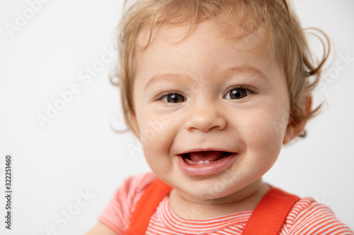 Close up portrait of smiling one year old baby