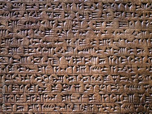 Ancient cuneiform writing script on the wall photo