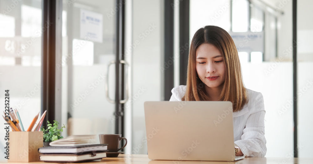 Concept business woman working and people happy businesswoman or creative female office worker with computers writing to notebook with documents and laptop. Concept business woman working and people happy businesswoman or creative female office worker with computers writing to notebook with documents and laptop.