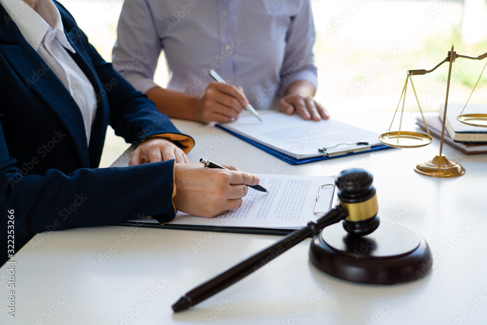 Female Lawyer explaining legal situation and discussing with contract papers, Concepts of law, justice and legal services Female Lawyer explaining legal situation and discussing with contract papers, Concepts of law, justice and legal services