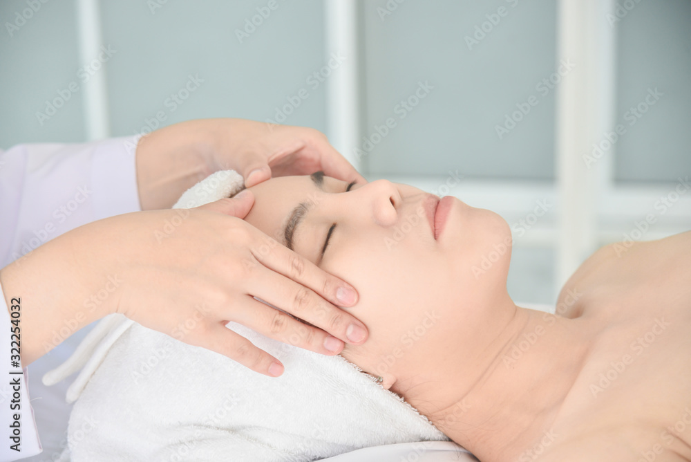 Therapist doing Tui na massage at her patient face ,Chinese alternative medicine.