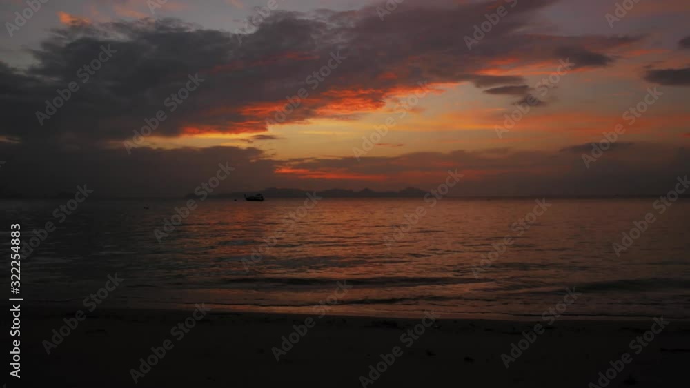 Glorious Sunrise Scenery In The Island Of Koh Kradan, Thailand With Boat Sailing Over The Calm Sea Under The Colourful Sky - Timelapse Glorious Sunrise Scenery In The Island Of Koh Kradan, Thailand With Boat Sailing Over The Calm Sea Under The Colourful Sky - Timelapse