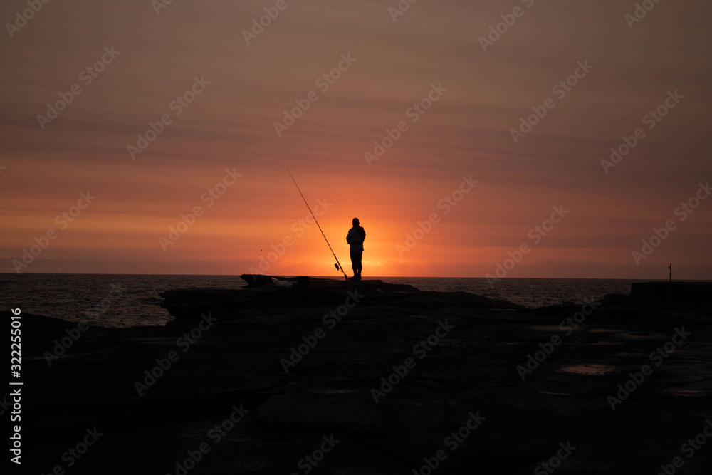 silhouette of fisherman at sunrise
