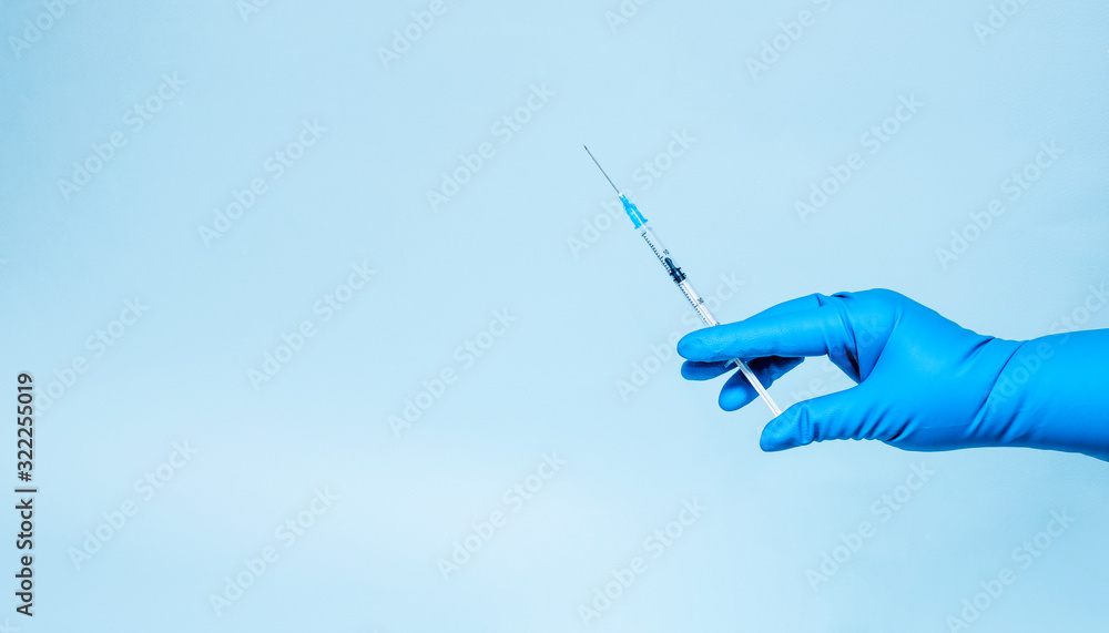Syringe in the hands in medical gloves. Medicine and vaccination. Banner. Copy space Syringe in the hands in medical gloves. Medicine and vaccination. Banner. Copy space