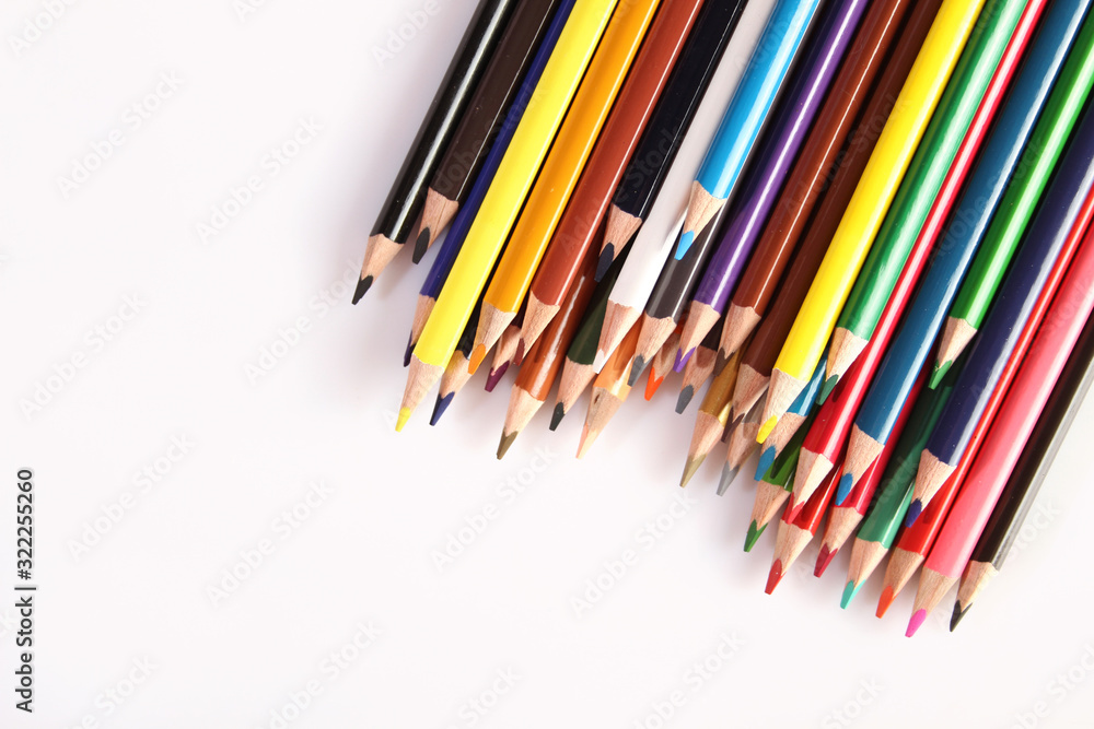 Colored pencils lie in a row