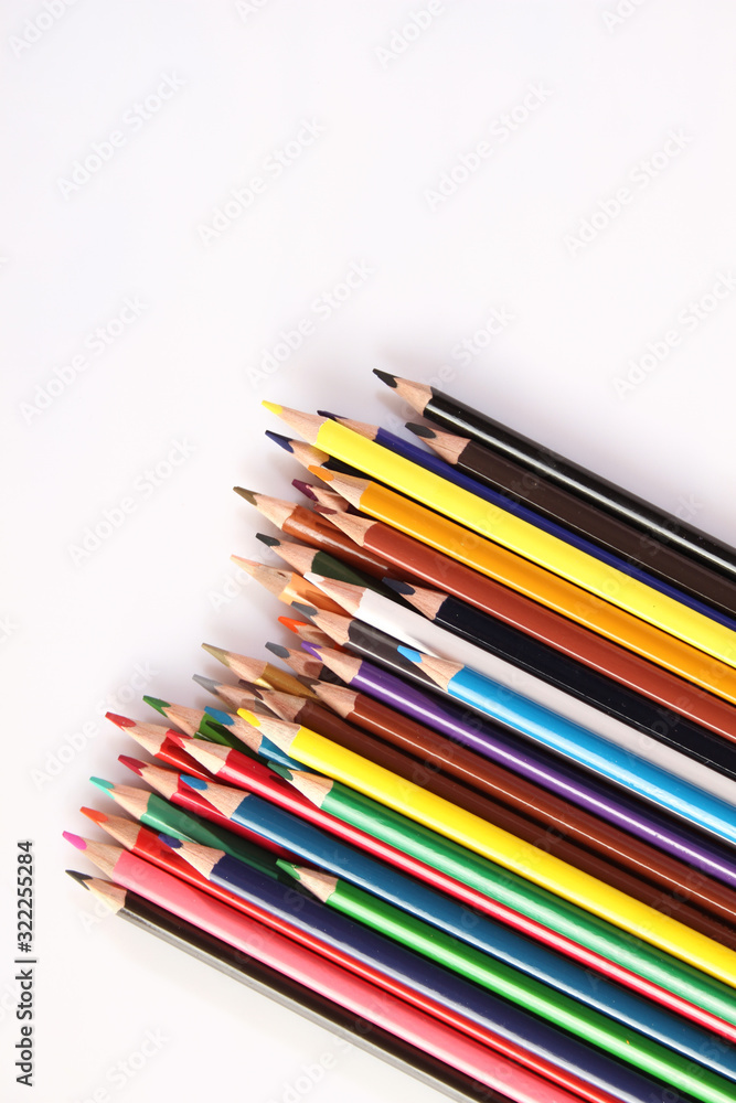Colored pencils lie in a row