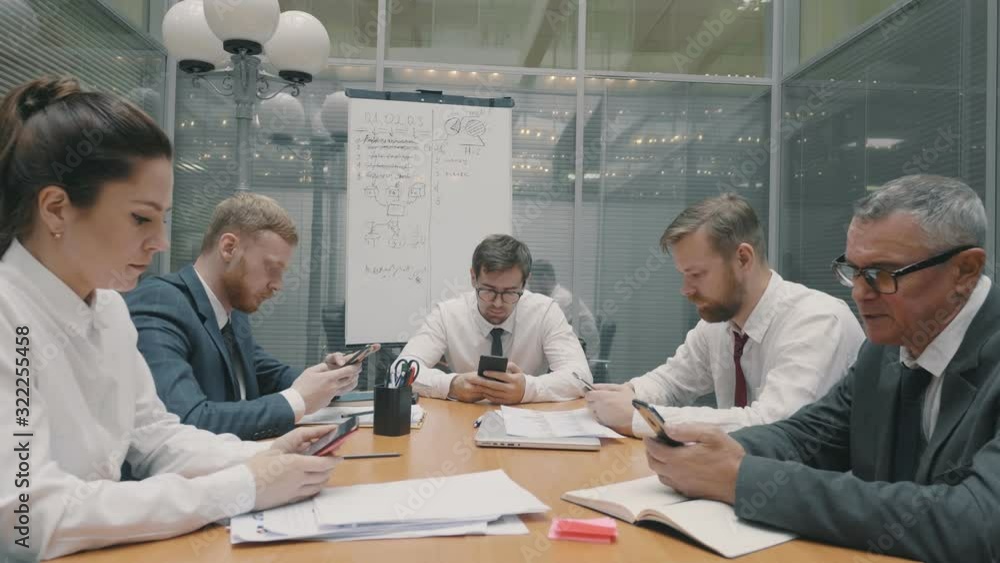 Colleagues use smartphones chatting surfing, looking for information. People do not talk to each other. Problem in commutication in office. Employees with phones Colleagues use smartphones chatting surfing, looking for information. People do not talk to each other. Problem in commutication in office. Employees with phones
