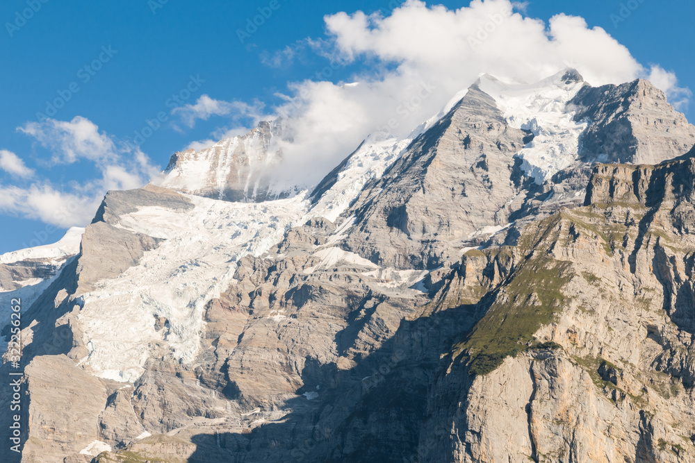 Bernese Alps panorama with Eiger glacier and cumulus clouds, Switzerland