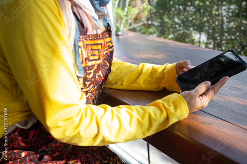 business owner young 25 s Muslim woman wearing hijab working with payments app smartphone, entrepreneur ready to welcome customers with confidence for success, The concept: small shop service retail