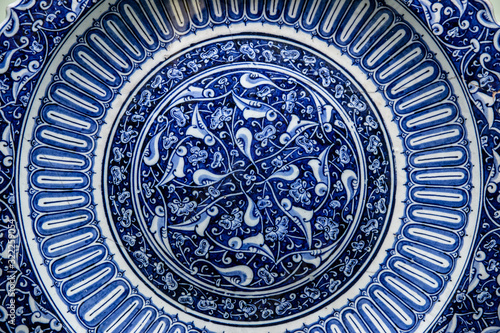 Texture of ceramic tiles in oriental East style. Turkish ceramic tiles lined on the wall. Old azulejo pattern floral ornament on floor. Ottoman traditional art. Moroccan portuguese mosaic background