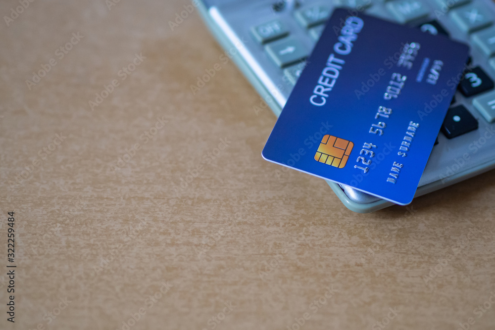 Close-up of a blue credit card is placed on calculator. Prepare for online shopping, credit card payment convenient and fast to buy products online by paying via credit card. E-commerce Concept Close-up of a blue credit card is placed on calculator. Prepare for online shopping, credit card payment convenient and fast to buy products online by paying via credit card. E-commerce Concept