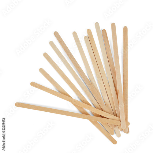 Wooden stirrers for coffee, tea and drinks, laid out in random order, isolated on a white background.