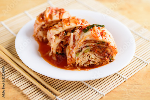 Kimchi cabbage on white plate and chopsticks, Korean food