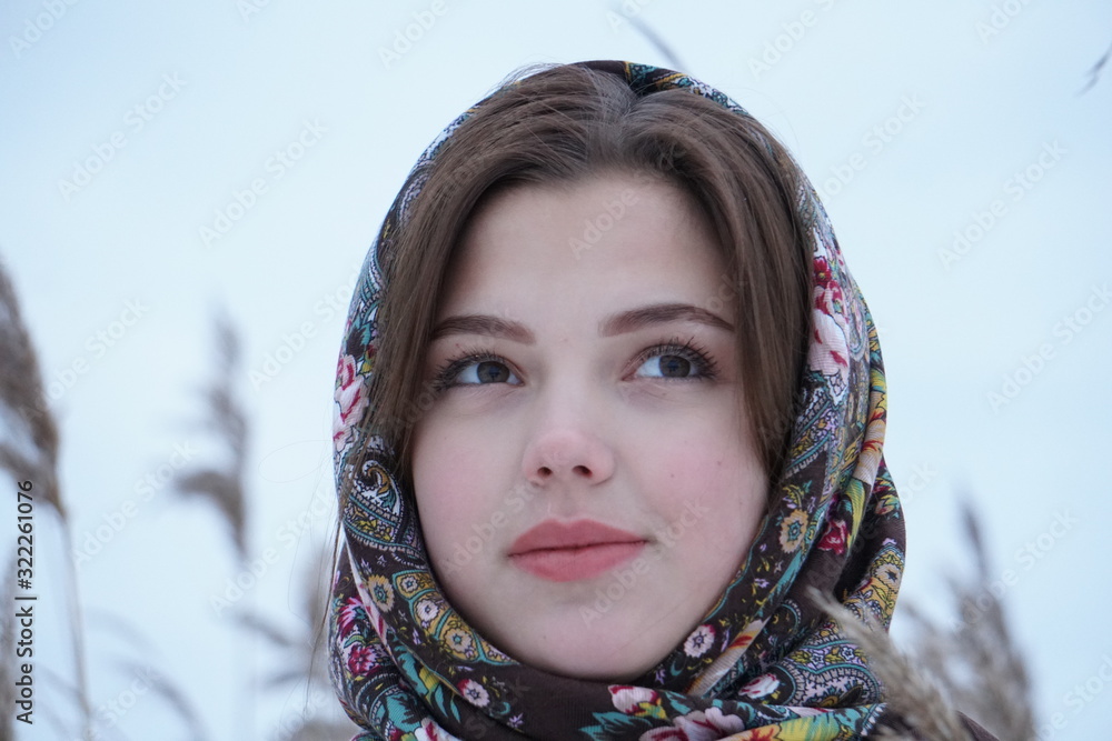 close-up portrait of a girl in a white sweater and openwork shawl on a background of nature close-up portrait of a girl in a white sweater and openwork shawl on a background of nature