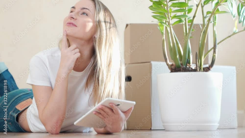 Woman arranging new apartment with digital tablet Woman arranging new apartment with digital tablet
