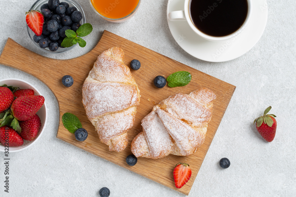 Fresh tasty croissants with berries. Traditional snack or breakfast. 